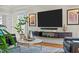 Bright living room featuring a large-screen TV, modern shelving, and comfortable leather seating at 501 Mallard Ave, Durham, NC 27701