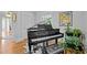 Elegant grand piano in a bright room, complemented by hardwood floors and stylish decor at 501 Mallard Ave, Durham, NC 27701