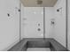 Modern shower with dual shower heads, clean white tiles and grey accent tiles at 501 Mallard Ave, Durham, NC 27701