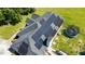 Aerial shot of the house's roof, completely covered in solar panels, overlooking a large grassy yard and trampoline at 5525 Sandy Trail Dr, Knightdale, NC 27545