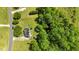 Aerial view of a house with solar panels, a trampoline, and an outdoor kitchen, surrounded by lush greenery at 5525 Sandy Trail Dr, Knightdale, NC 27545