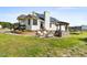 Backyard with solar panels, stone patio, outdoor kitchen, and seating area at 5525 Sandy Trail Dr, Knightdale, NC 27545