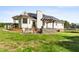 The backyard features a stone grill with pergola cover, a white house with solar panels, and a trampoline at 5525 Sandy Trail Dr, Knightdale, NC 27545