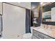 Well-lit bathroom features gray vanity with marble countertop and a tiled shower with blue curtain at 5525 Sandy Trail Dr, Knightdale, NC 27545