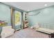 Bright bedroom with a crib, toy kitchen, cozy chair, and charming decor, ideal for a Bedroom at 5525 Sandy Trail Dr, Knightdale, NC 27545