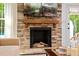 Living room fireplace with stone surround and wooden mantel at 5525 Sandy Trail Dr, Knightdale, NC 27545