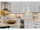 Well-lit kitchen with white cabinets, stainless steel appliances, and beautiful countertop space at 5525 Sandy Trail Dr, Knightdale, NC 27545