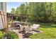 Outdoor patio with a grill, dining area, and lounge seating, perfect for entertaining and relaxation at 5525 Sandy Trail Dr, Knightdale, NC 27545