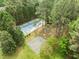An aerial view of the tennis court, basketball court, and picnic shelter in a wooded area at 608 Valen Ct, Chapel Hill, NC 27516