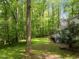 A spacious backyard with lots of green trees with a house and deck at 608 Valen Ct, Chapel Hill, NC 27516