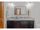 Powder room featuring a marble countertop, black vanity, modern fixtures, and stylish decor at 608 Valen Ct, Chapel Hill, NC 27516