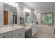 Bathroom featuring double sinks, a vanity, and a garden tub at 608 Valen Ct, Chapel Hill, NC 27516
