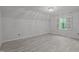 Bright bedroom with hardwood floors, modern light fixture, and windows offering natural light at 608 Valen Ct, Chapel Hill, NC 27516