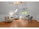 Bright bonus room with light wood floors, vaulted ceilings, skylight, ceiling fan, and study nook with window at 608 Valen Ct, Chapel Hill, NC 27516