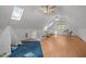 Bright bonus room with light wood floors, vaulted ceilings, skylight, ceiling fan, and study nook with window at 608 Valen Ct, Chapel Hill, NC 27516