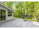 Spacious deck with a grill and view of the surrounding wooded property at 608 Valen Ct, Chapel Hill, NC 27516