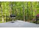 View of the deck with grill overlooking wooded property at 608 Valen Ct, Chapel Hill, NC 27516