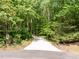 Long driveway leading to home with wooded area at 608 Valen Ct, Chapel Hill, NC 27516