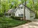 Beautiful home exterior with a covered porch, lush greenery, and an attached garage, nestled among trees at 608 Valen Ct, Chapel Hill, NC 27516