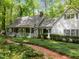 Charming white home with a welcoming front porch and beautifully landscaped garden path at 608 Valen Ct, Chapel Hill, NC 27516