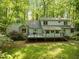 Exterior view of home with backyard deck, grill, backing up to wooded area at 608 Valen Ct, Chapel Hill, NC 27516