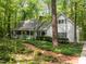 Charming home featuring a welcoming front porch, lush landscaping, and a brick path leading to the entrance at 608 Valen Ct, Chapel Hill, NC 27516