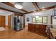 Open concept kitchen with a large island, stainless steel refrigerator, and plenty of cabinet space at 608 Valen Ct, Chapel Hill, NC 27516