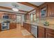 Traditional kitchen with wood cabinets, stainless steel appliances, granite counters and view into the dining room at 608 Valen Ct, Chapel Hill, NC 27516