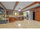 Spacious kitchen boasting custom cabinets, granite countertops, stainless steel appliances, and wood beam details at 608 Valen Ct, Chapel Hill, NC 27516