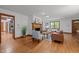 Open living room featuring hardwood floors, a fireplace, and easy access to the kitchen and dining areas at 608 Valen Ct, Chapel Hill, NC 27516