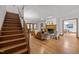 Open living room with wood floors, fireplace, stairs, and access to dining area at 608 Valen Ct, Chapel Hill, NC 27516