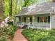 Charming white home with a welcoming front porch and beautifully landscaped garden path at 608 Valen Ct, Chapel Hill, NC 27516