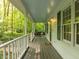 A covered front porch featuring a swing and overhead lighting creates a welcoming entrance to the home at 608 Valen Ct, Chapel Hill, NC 27516