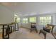 Cozy sunroom with wicker chairs, table, and multiple windows to enjoy nature at 608 Valen Ct, Chapel Hill, NC 27516