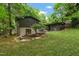 Sprawling backyard features green grass, trees, and a screened-in porch at 6421 Arrington Rd, Raleigh, NC 27607