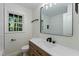 This modern bathroom features a vanity with drawers, a white counter, and a built-in shower niche at 6421 Arrington Rd, Raleigh, NC 27607
