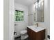 This contemporary bathroom offers a modern vanity, stylish fixtures, and a large window with a lush green view at 6421 Arrington Rd, Raleigh, NC 27607