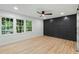 Bedroom featuring three windows and a decorative wood wall at 6421 Arrington Rd, Raleigh, NC 27607