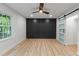 This spacious bedroom features a modern ceiling fan, wood-look floors, and custom closet with a sliding barn door at 6421 Arrington Rd, Raleigh, NC 27607