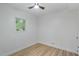 This simple bedroom features wood-look floors and a bright window overlooking luscious landscaping at 6421 Arrington Rd, Raleigh, NC 27607