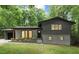 Charming home featuring an attached garage, gray brick, black trim, and lush green lawn at 6421 Arrington Rd, Raleigh, NC 27607