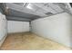 Spacious garage with white painted brick and concrete flooring at 6421 Arrington Rd, Raleigh, NC 27607