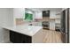 Bright kitchen with white cabinets, stainless steel appliances, quartz countertops and a view of nature at 6421 Arrington Rd, Raleigh, NC 27607