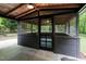 Screened porch area with door and view of backyard landscaping at 6421 Arrington Rd, Raleigh, NC 27607
