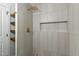 This luxurious shower features floor to ceiling tile, a rainfall shower head, and a built-in niche for storage at 6421 Arrington Rd, Raleigh, NC 27607
