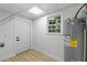 Bright utility room with water heater, storage and access to backyard at 6421 Arrington Rd, Raleigh, NC 27607