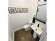 Bright bathroom featuring a toilet, streamlined sink, stylish mirror, and tasteful decor at 665 Lonach Ln, Roxboro, NC 27574