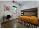 Bright bedroom featuring a wooden loft bed, modern desk, and an abstract rug at 665 Lonach Ln, Roxboro, NC 27574