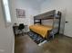 A charming bedroom featuring a wooden loft bed, study desk, and black and white accent rug at 665 Lonach Ln, Roxboro, NC 27574