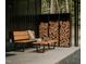 Inviting outdoor space with wood storage, bench, and coffee table, perfect for relaxation at 665 Lonach Ln, Roxboro, NC 27574